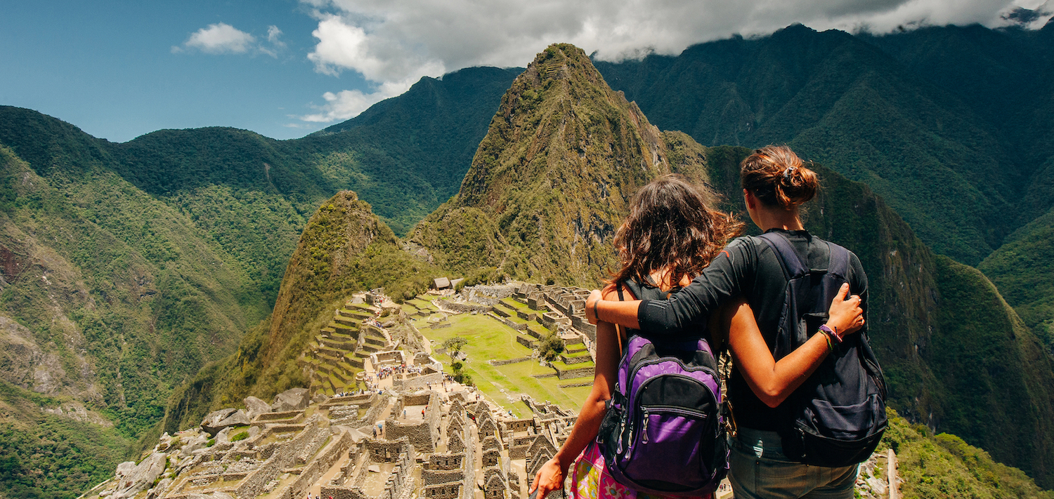 Couple looking at the Lost city of the Incas, Machu Picchu,