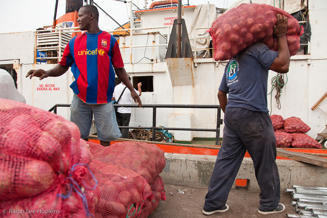 Workers unloading produce bound for the Galapagos in Guayaquil, Ecuador