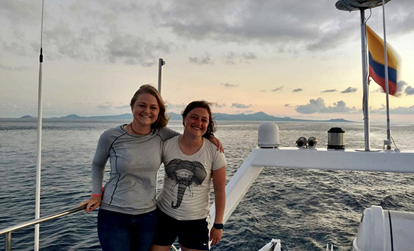 Galapagos tour guests on a small ship at sunset