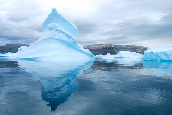 Cloudy skies in Sermilik Fjord's "iceberg graveyard" lend a mysterious quality to the Arctic landscape.