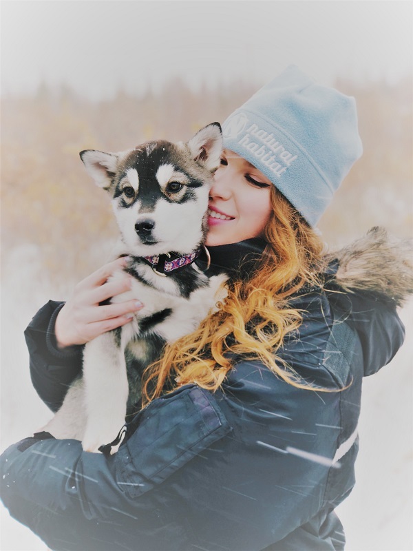 Emily Goodheart with a husky puppy in Churchill, Manitoba. 