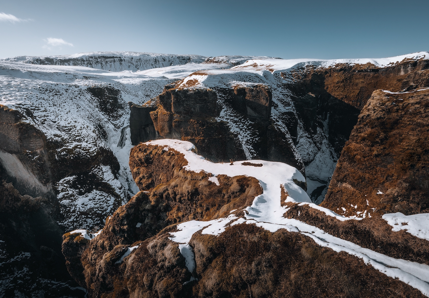 Aerial Drone view of Fjadrargljufur canyon and Fjadra river at winter. White snow and blue river. Iceland near Reykjavik.