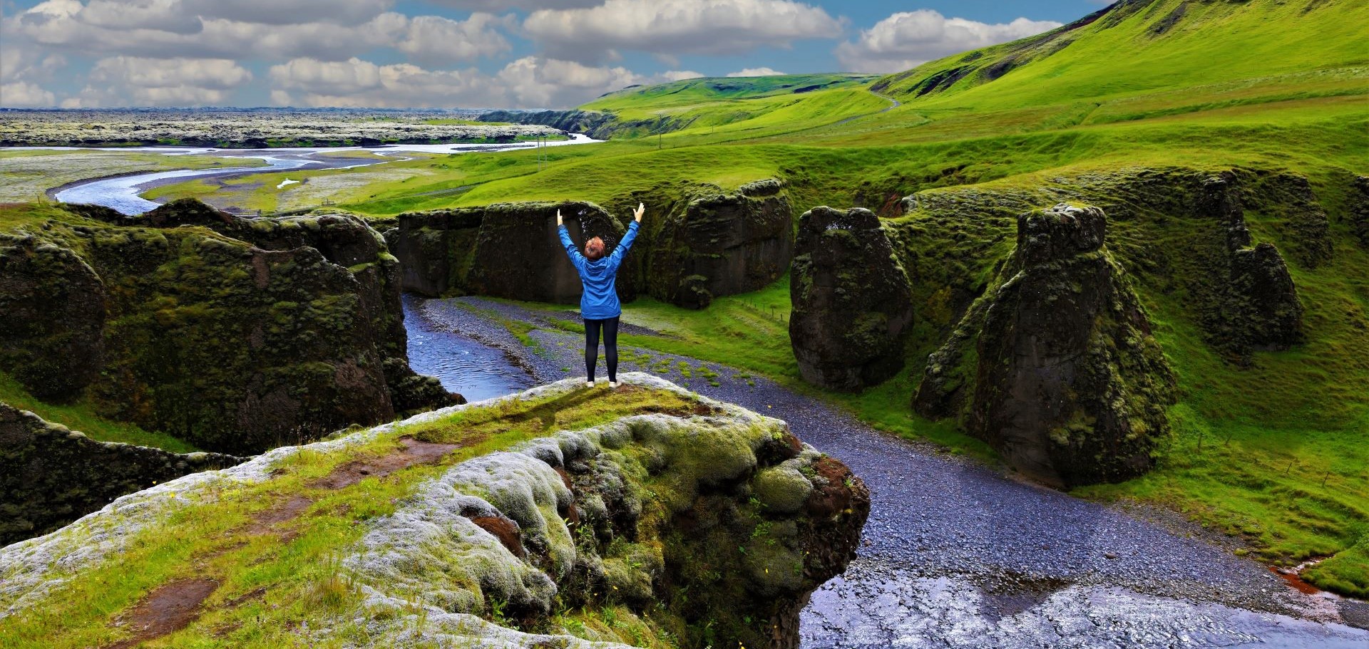 Woman standing at the top of a scenic cliff