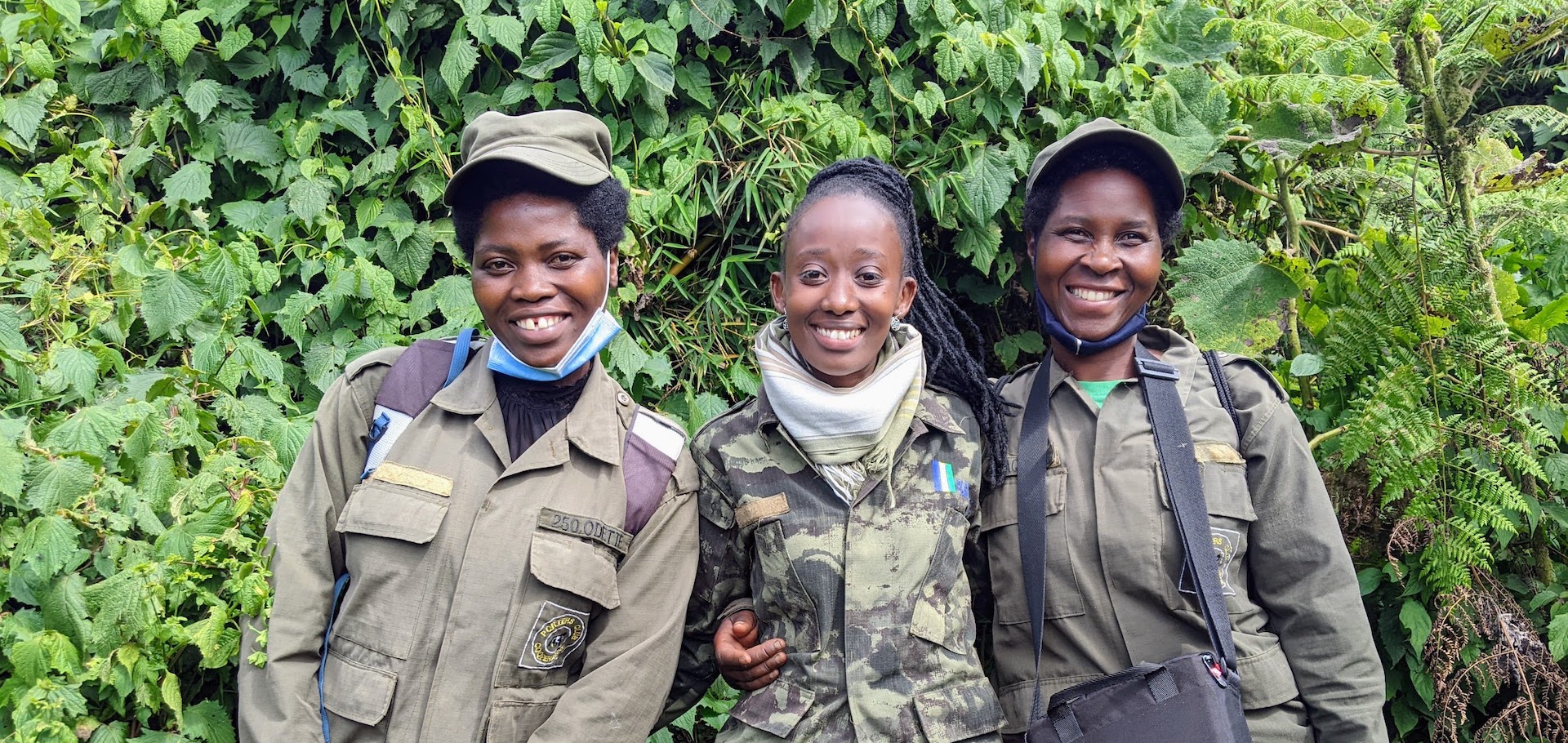 Odette Uwineza (porter), Jolie Mukiza (guide) and Jacqueline Uwamahoro (porter) on a gorilla trek in Rwanda.