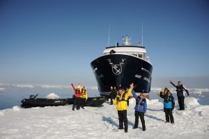 Yacht Hanse Explorer Arctic expedition smiling and waving passengers and crew