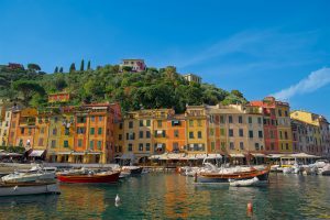 Beautiful charming sea side village in Italy with colorful buildings and boats in the harbor