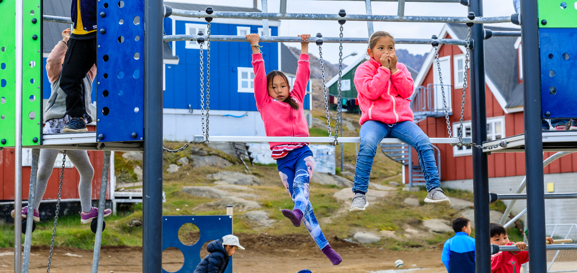Inuit children playing on jungle gym in Greenland