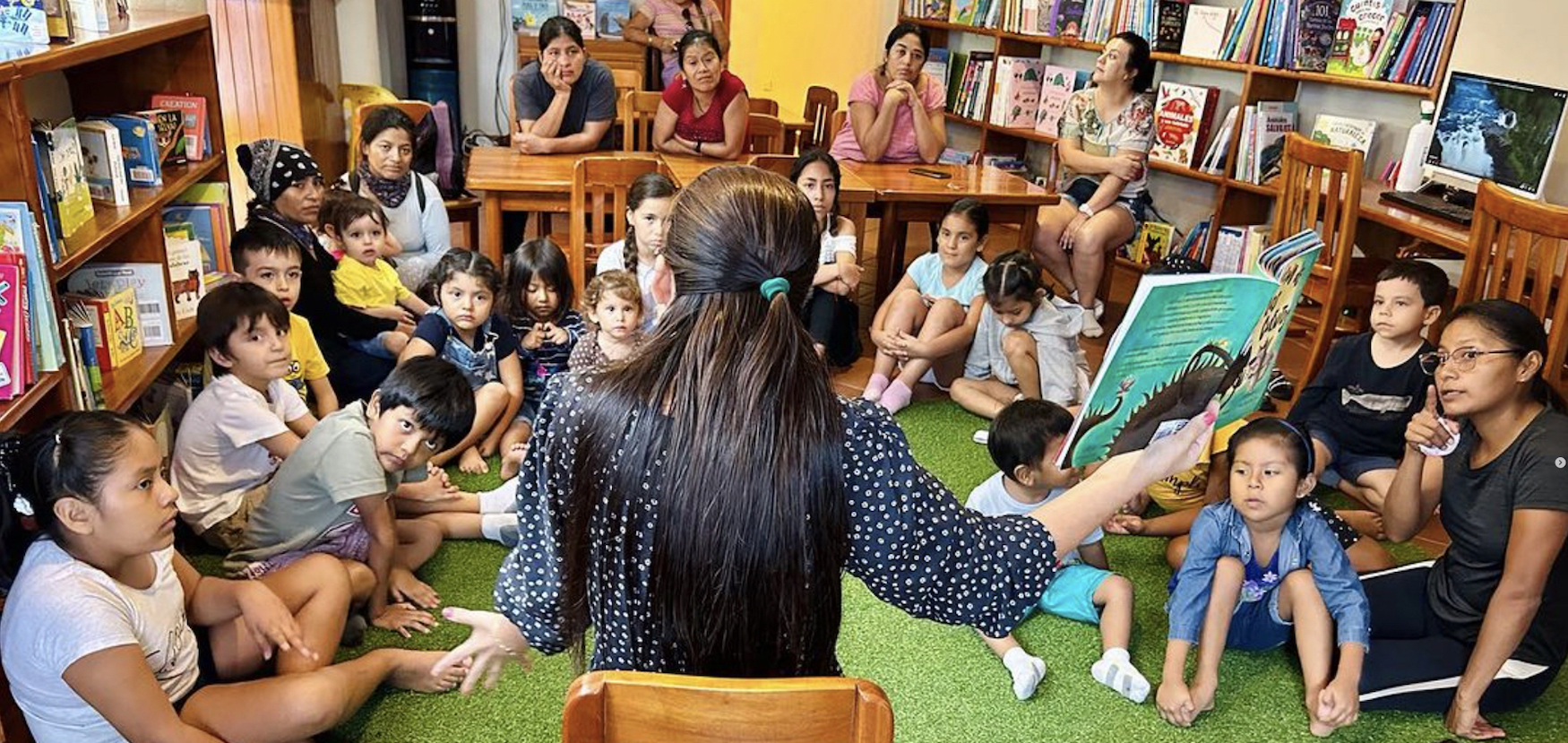 Reading to children at the Library of the Galapagos.