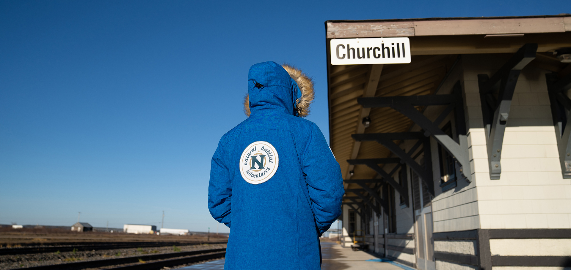 Nat Hab traveler wearing blue winter parka in churchill manitoba canada