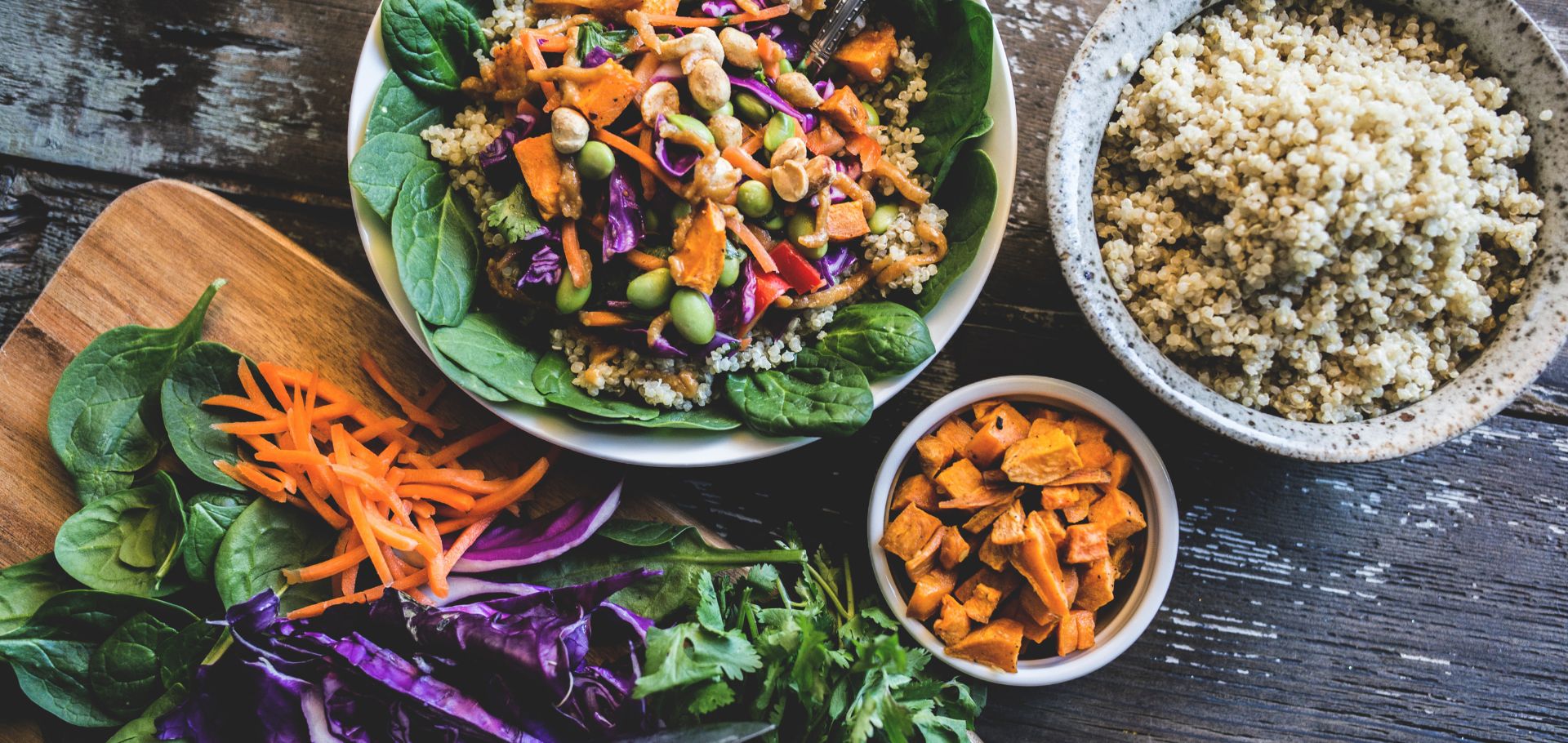 Healthy looking bowl off food including carrots, cabbage, salad leaves and quinoa.