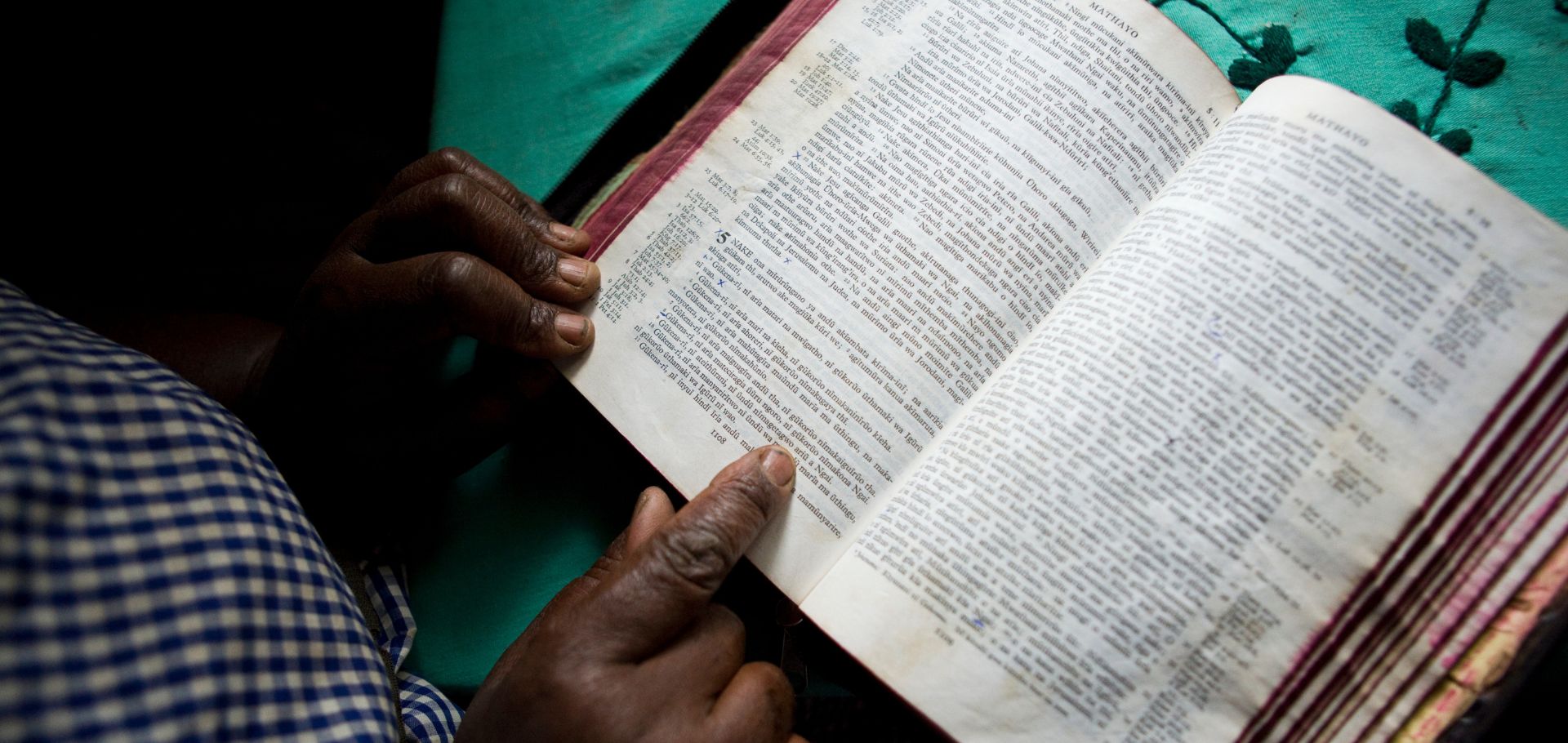 Margaret Wanjiru Mundia, a farmer, reads the bible at home.