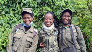 Odette Uwineza (porter), Jolie Mukiza (guide) and Jacqueline Uwamahoro (porter) on a gorilla trek in Rwanda.