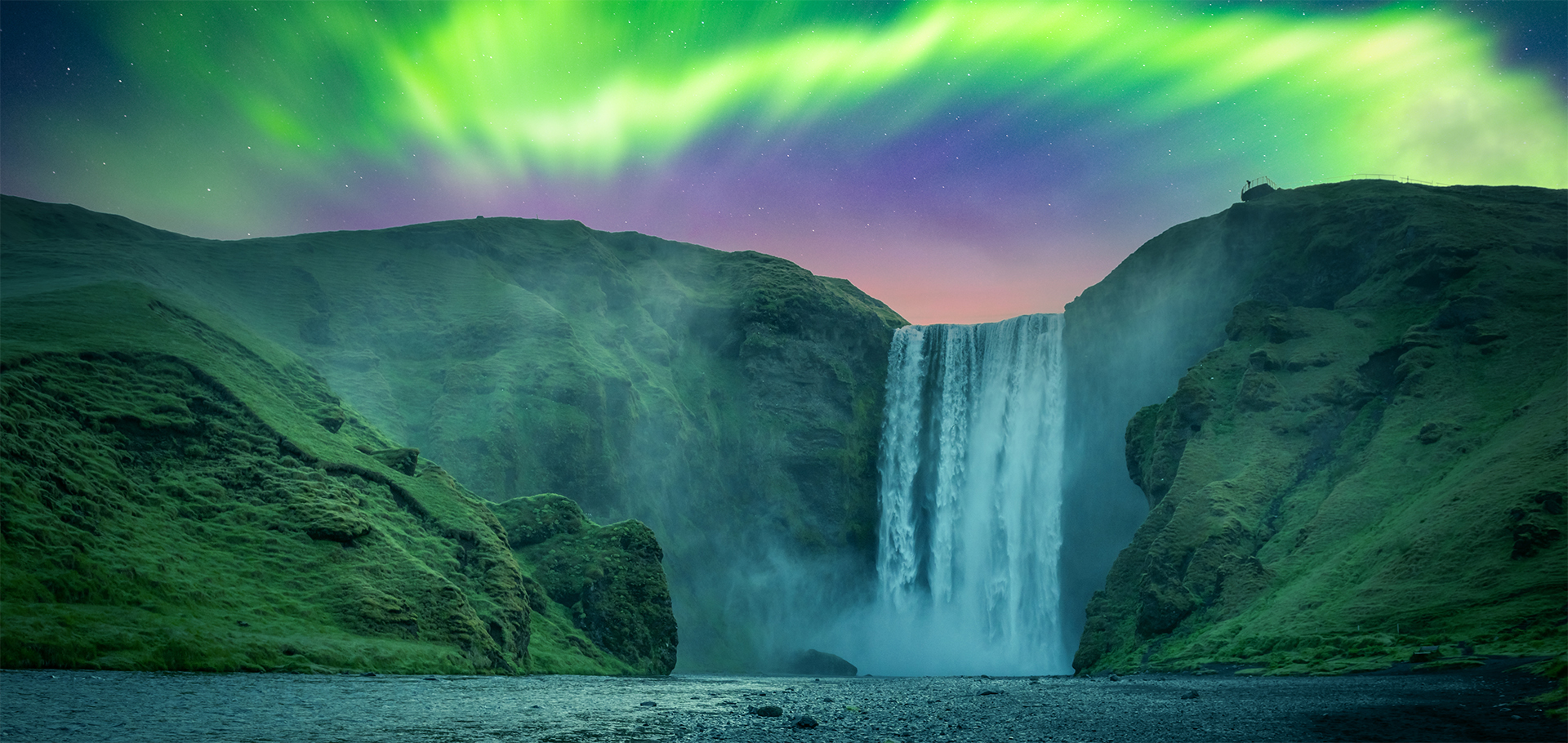 Iceland waterfall at night with northern lights