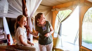 Family mother and her child in safari tent enjoying vacation in Africa