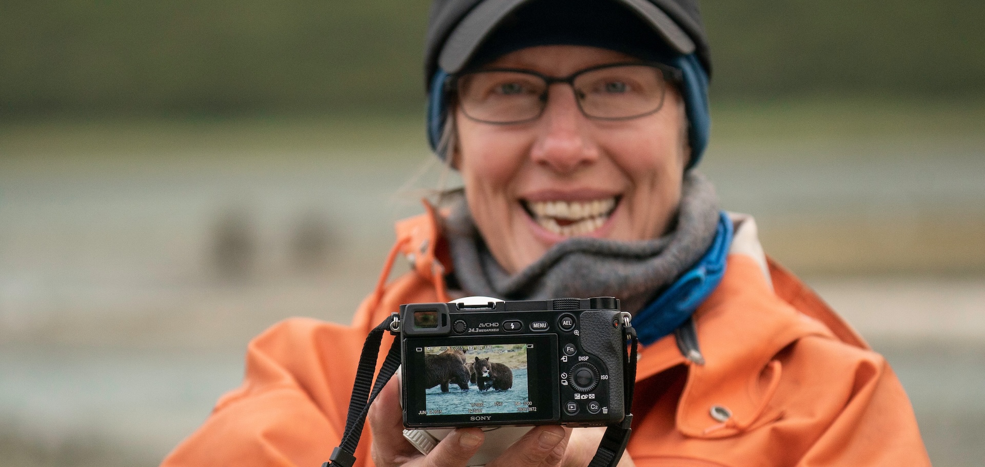 Guest proudly shows her photograph of grizzly bears, Alaska.