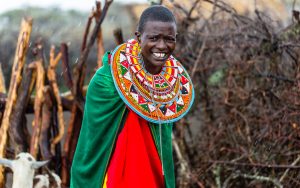 Massai woman standing in her village
