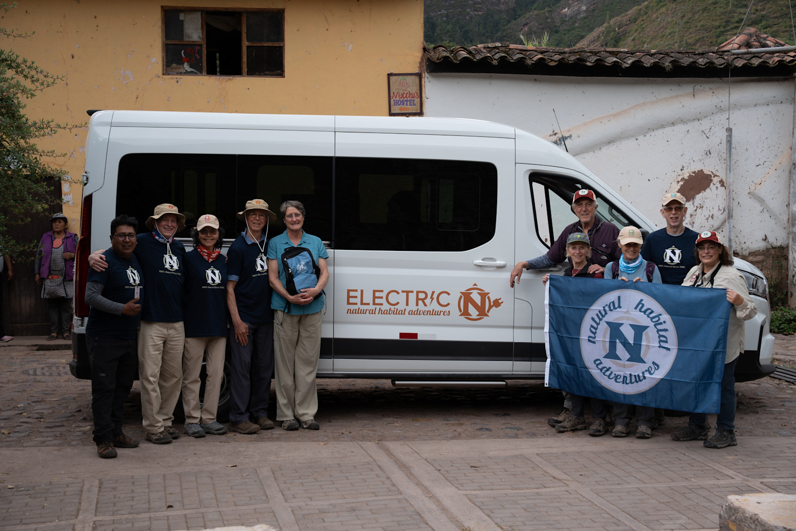 Nat Hab guests with Nat Hab's Electric Vehicle in Peru