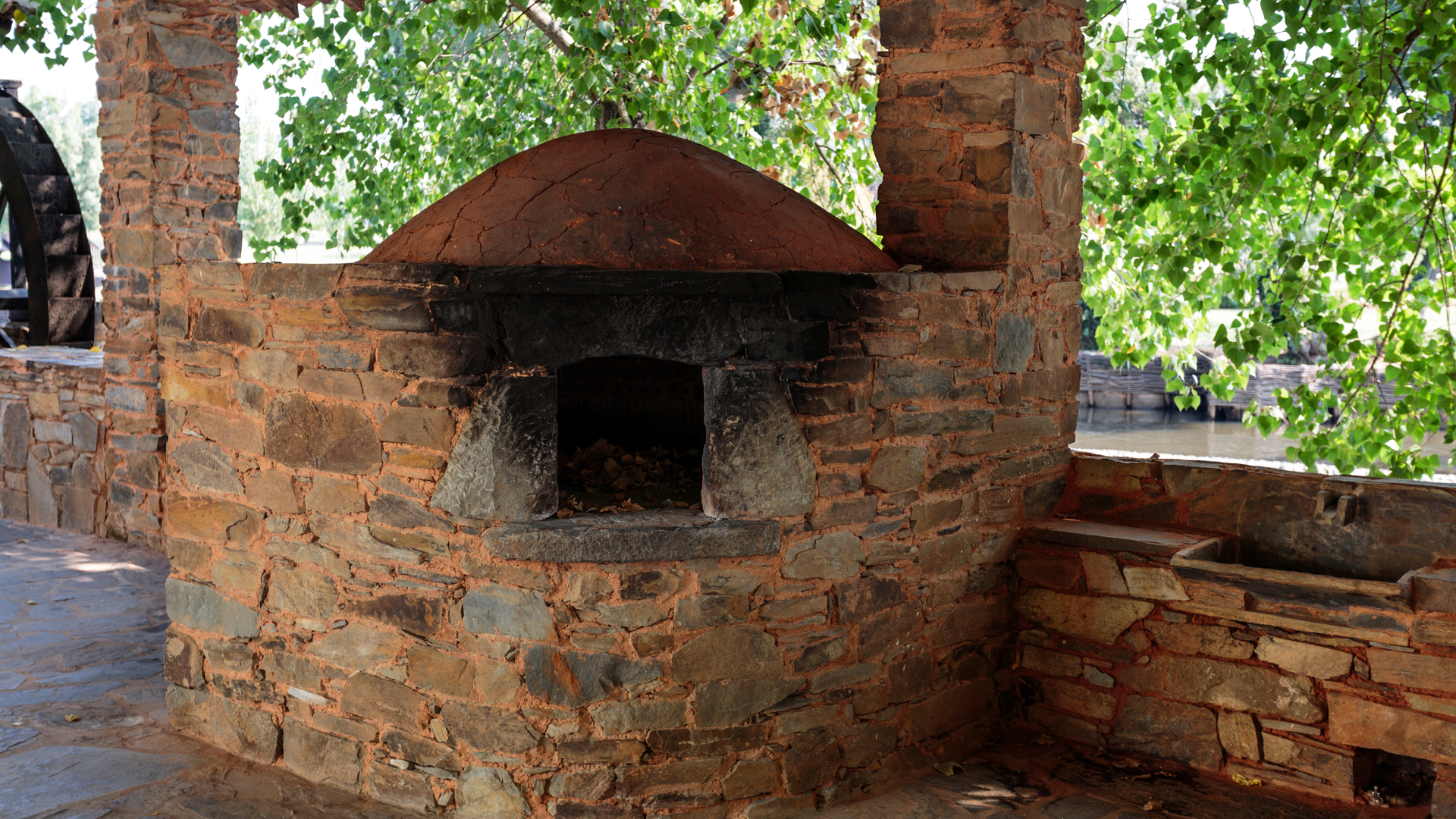 View of replica of the communal wood fired masonry oven located at the tilia and oak trees promenade in Serta, Portugal