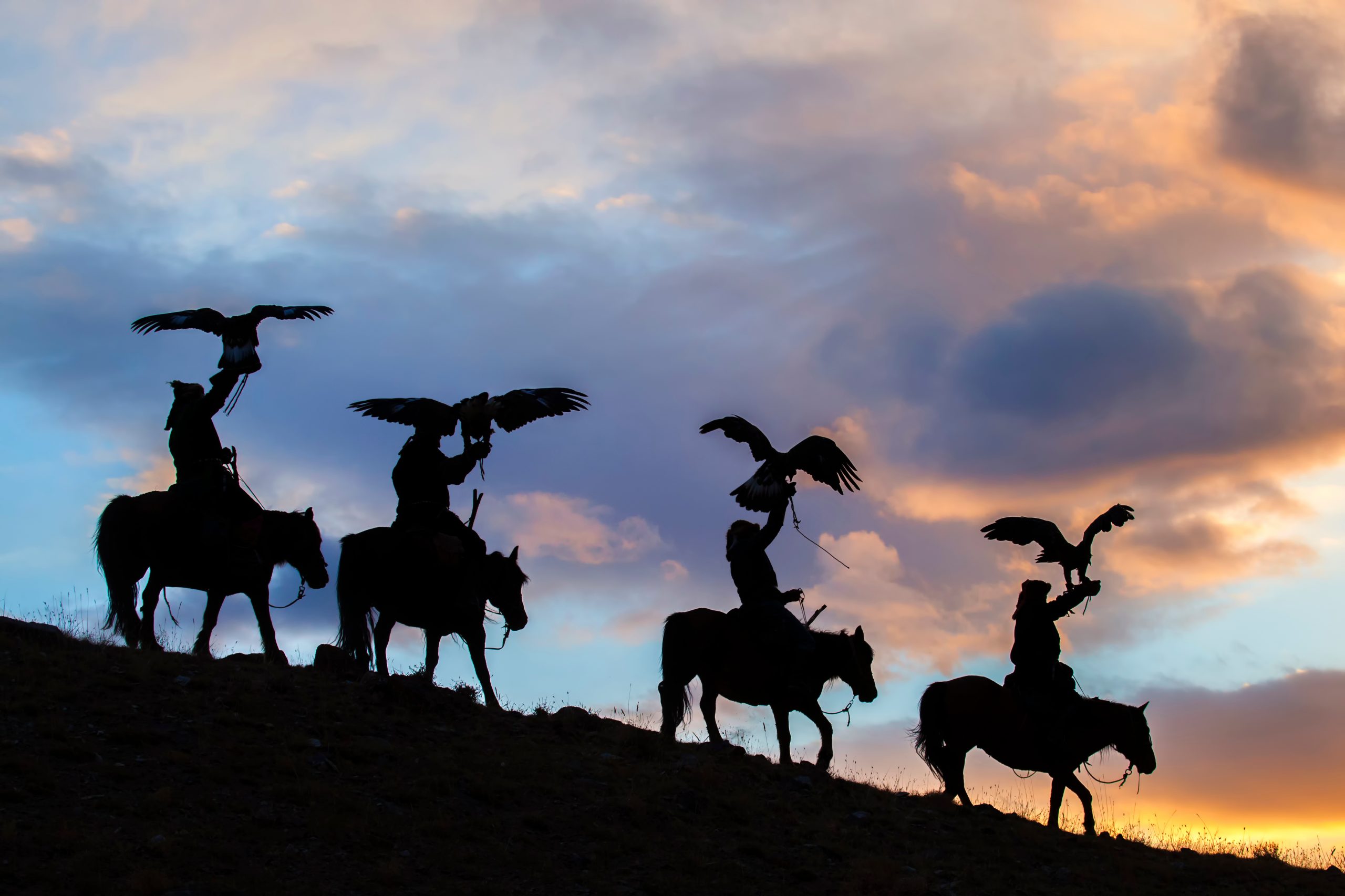 Silhouette of Mongolian Eagle Hunters near Ulgii, Mongolia