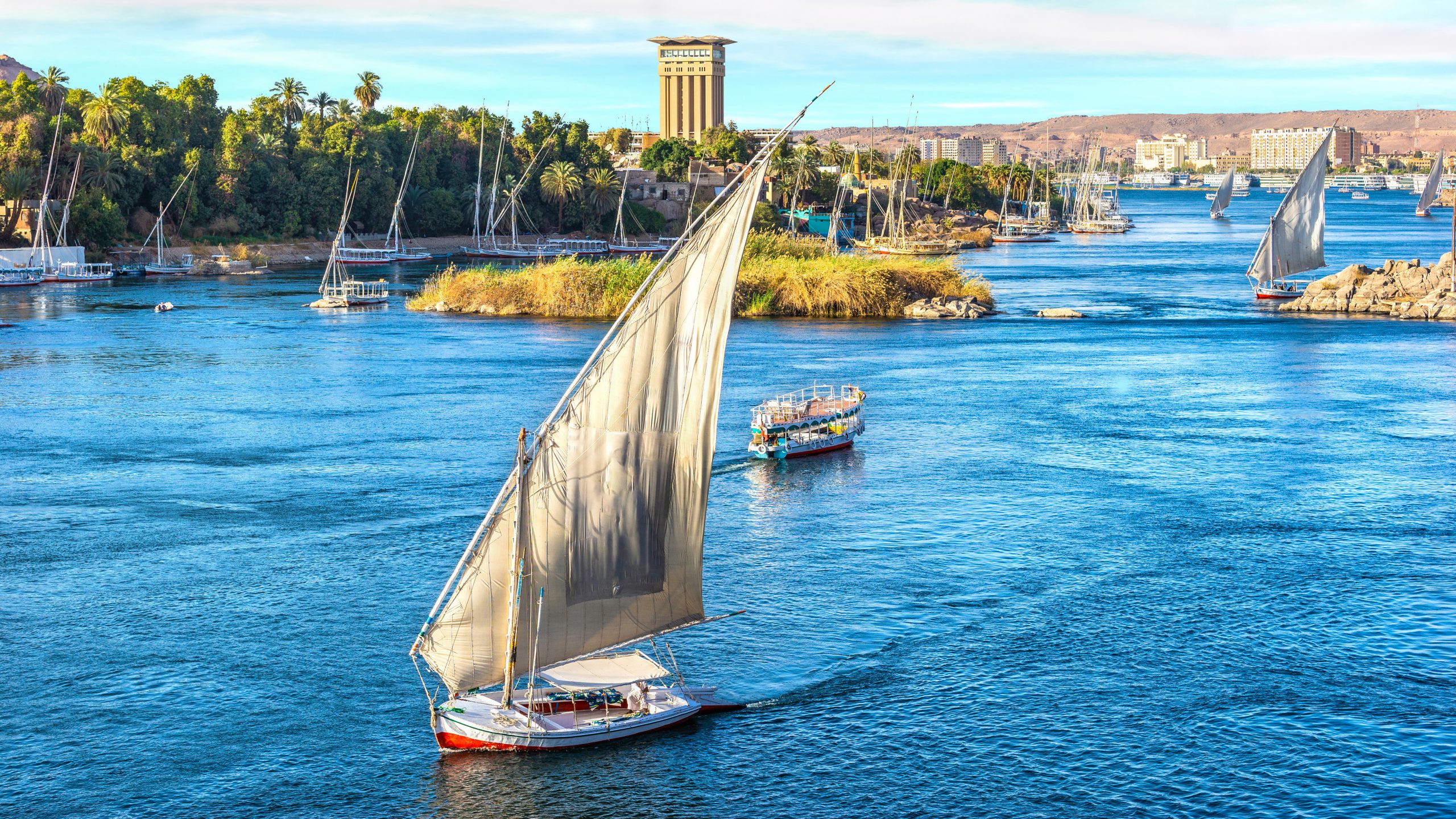 Dahabiya, Sunset over sailboats on river Nile in Aswan, Egypt
